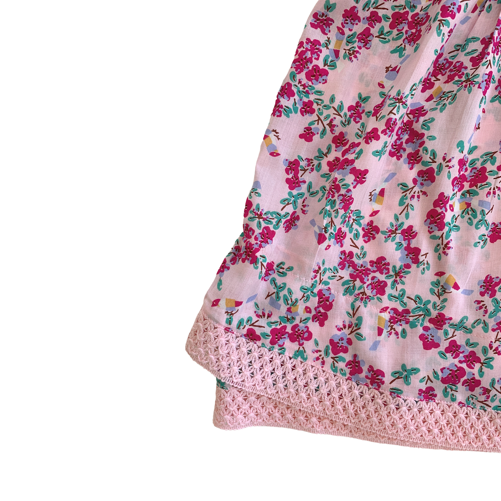Lace detail on Poupette St Barth Children's Sasha lace trimmed mini dress in pink kookoo bird print