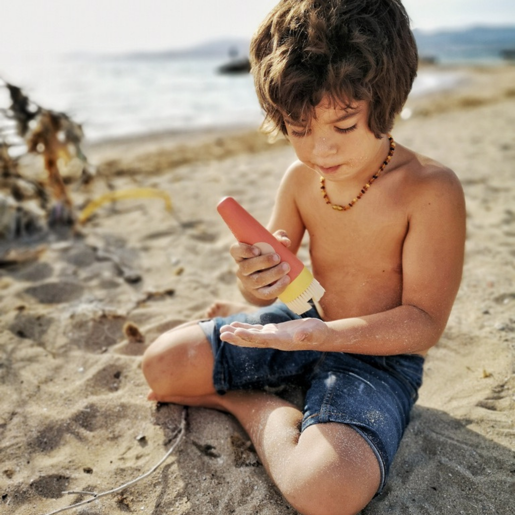Boy using SavviSand Sand Removal applicator 