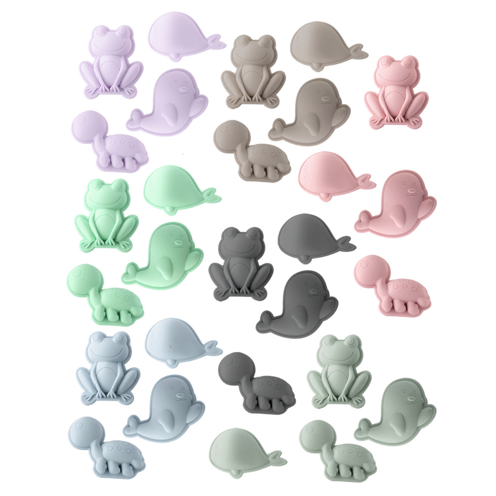 Collection of Scrunch silicone sand moulds in the frog set featuring frog, whale, seal and turtle in anthracite grey, duck egg blue, mushroom, old rose, pale lavender, sage green and spearmint