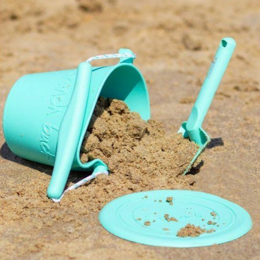 Scrunch silicone bucket, spade and foldable flyer on the beach