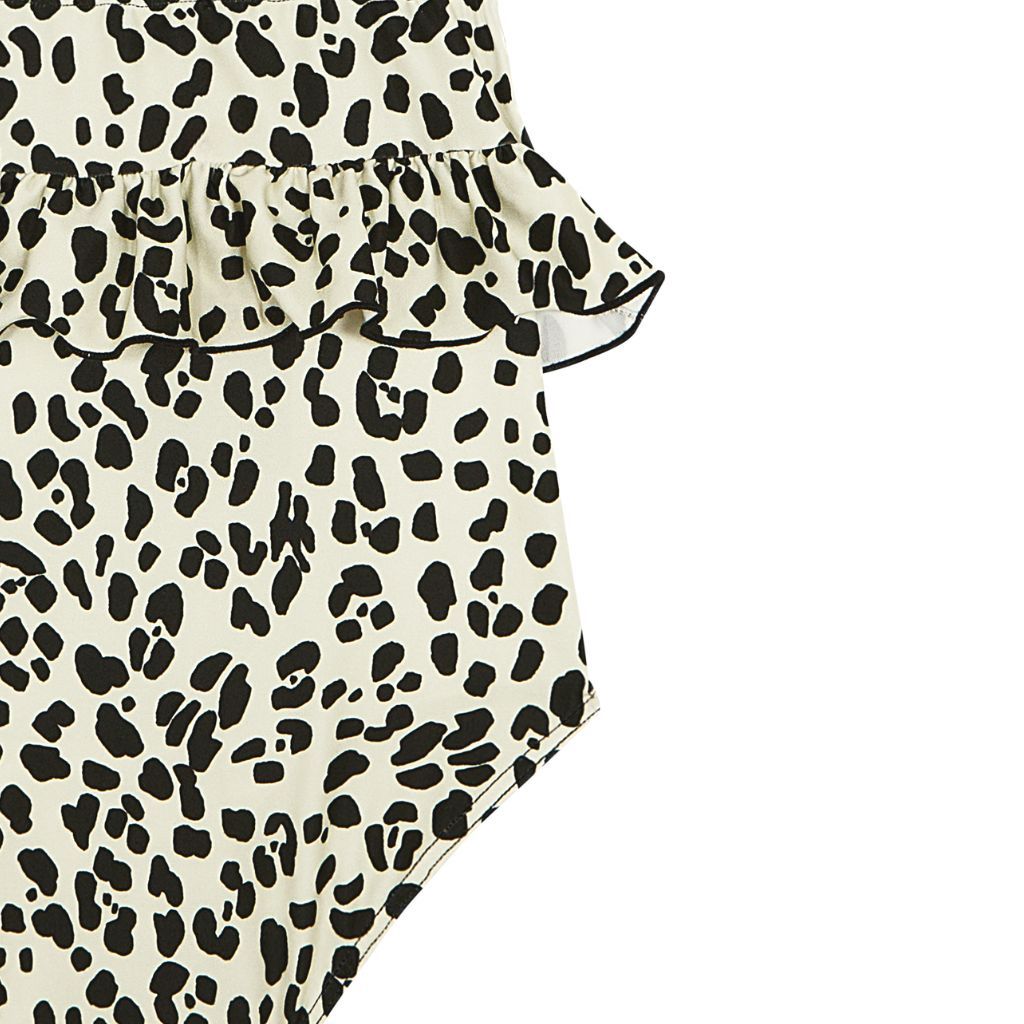 Close up of the fabric on the Suncracy Ivory Animal Print Amalfi Smocked Swimsuit for baby girls, toddler girls and girls