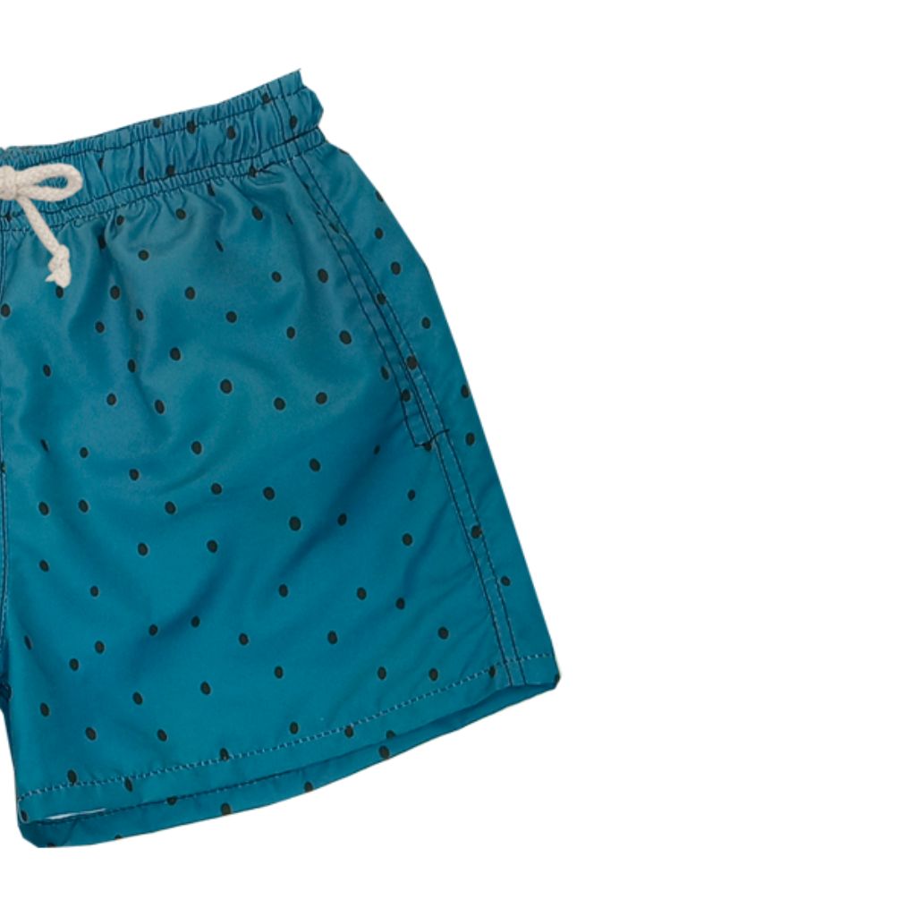Close up product shot of the Suncracy Teal Dots Santorini Tactel fast dry swim shorts for boys