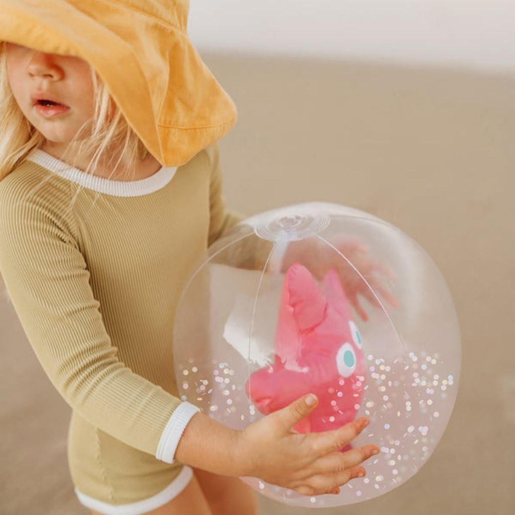 Little girl holding Sunnylife 3D inflatable beach ball in Ocean Treasure Rose