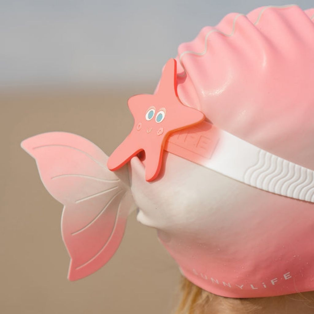Close up of Sunnylife Kids mini swim goggles in ocean treasure rose with starfish