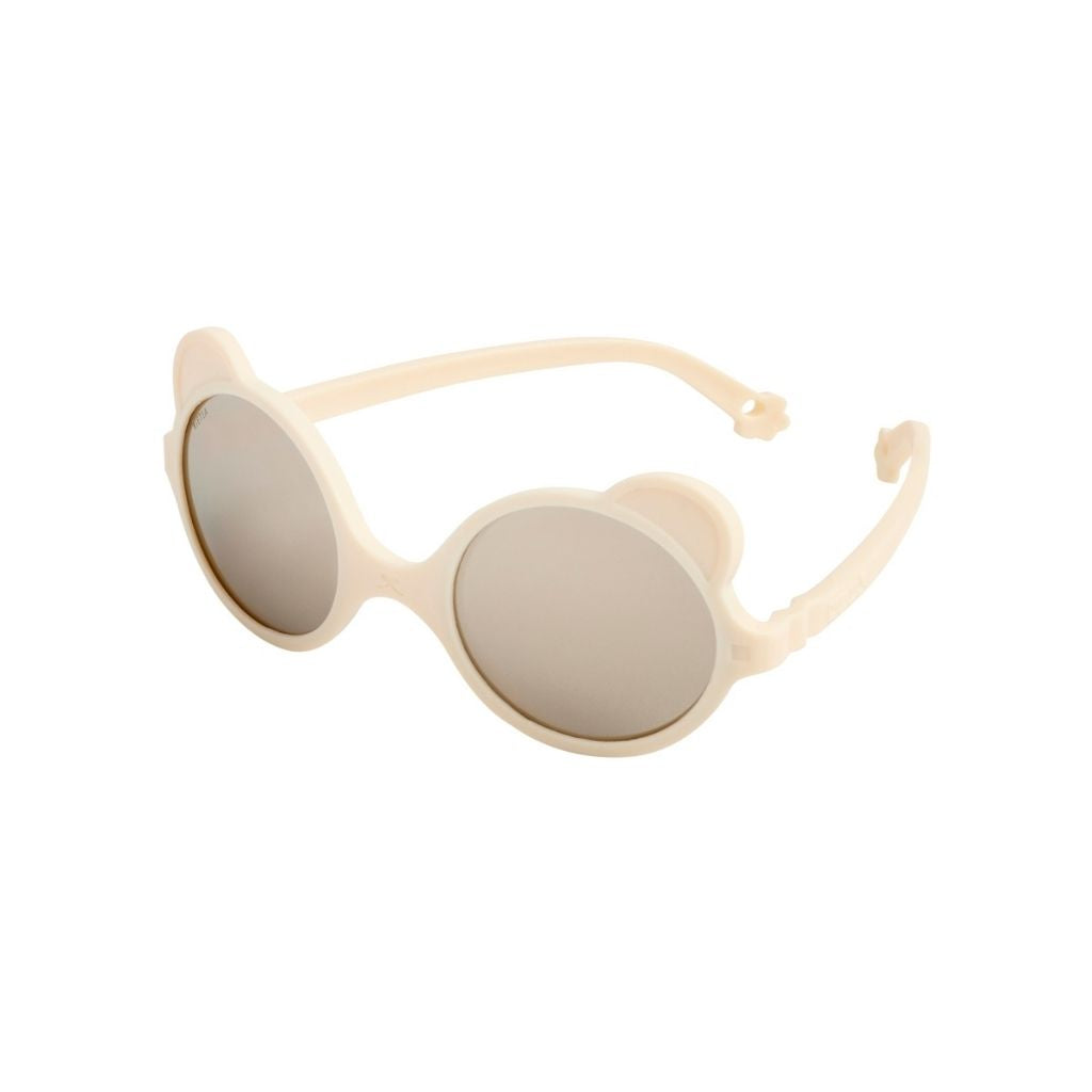 Side view of Ki et La Ours'on baby sunglasses in cream